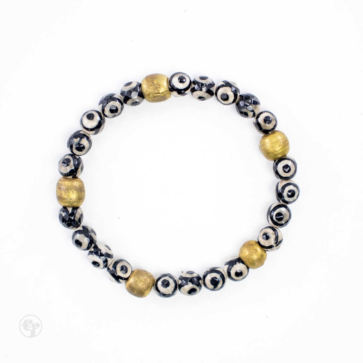 Bracelet with black and cream patterned beads and five gold-tone accent beads on a white background.