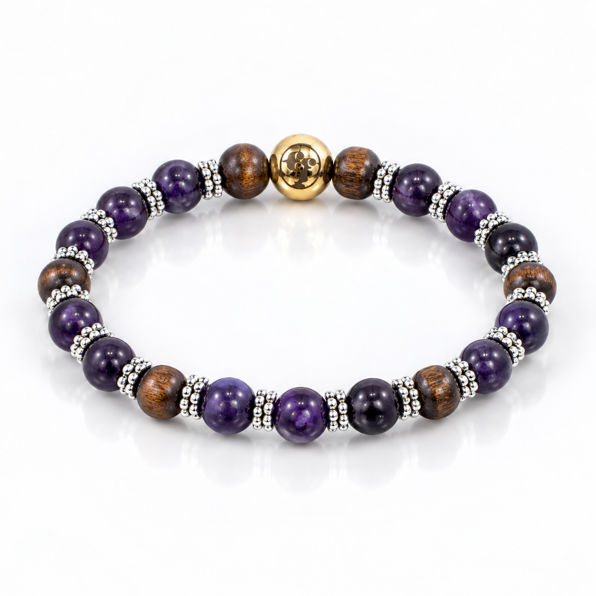 Angled view of purple amethyst and brown wood beads with silver-tone spacers and a gold-tone emblem bead.