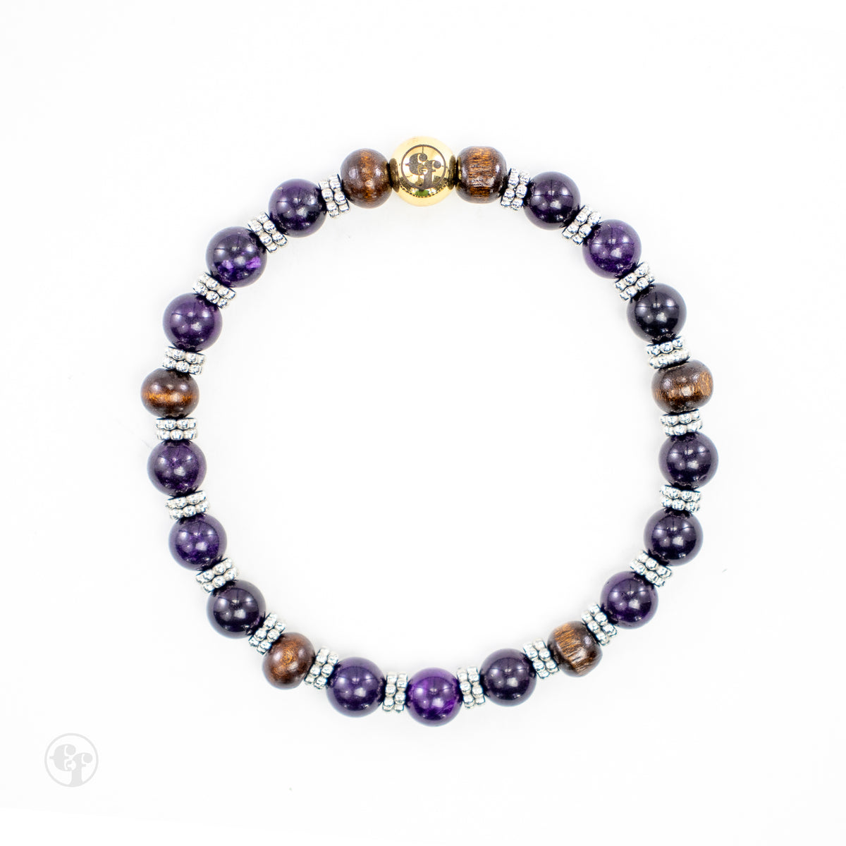 Top-down view of amethyst and brown wood beads with dotted silver-tone spacers and a polished gold-tone Ed Fountain emblem.