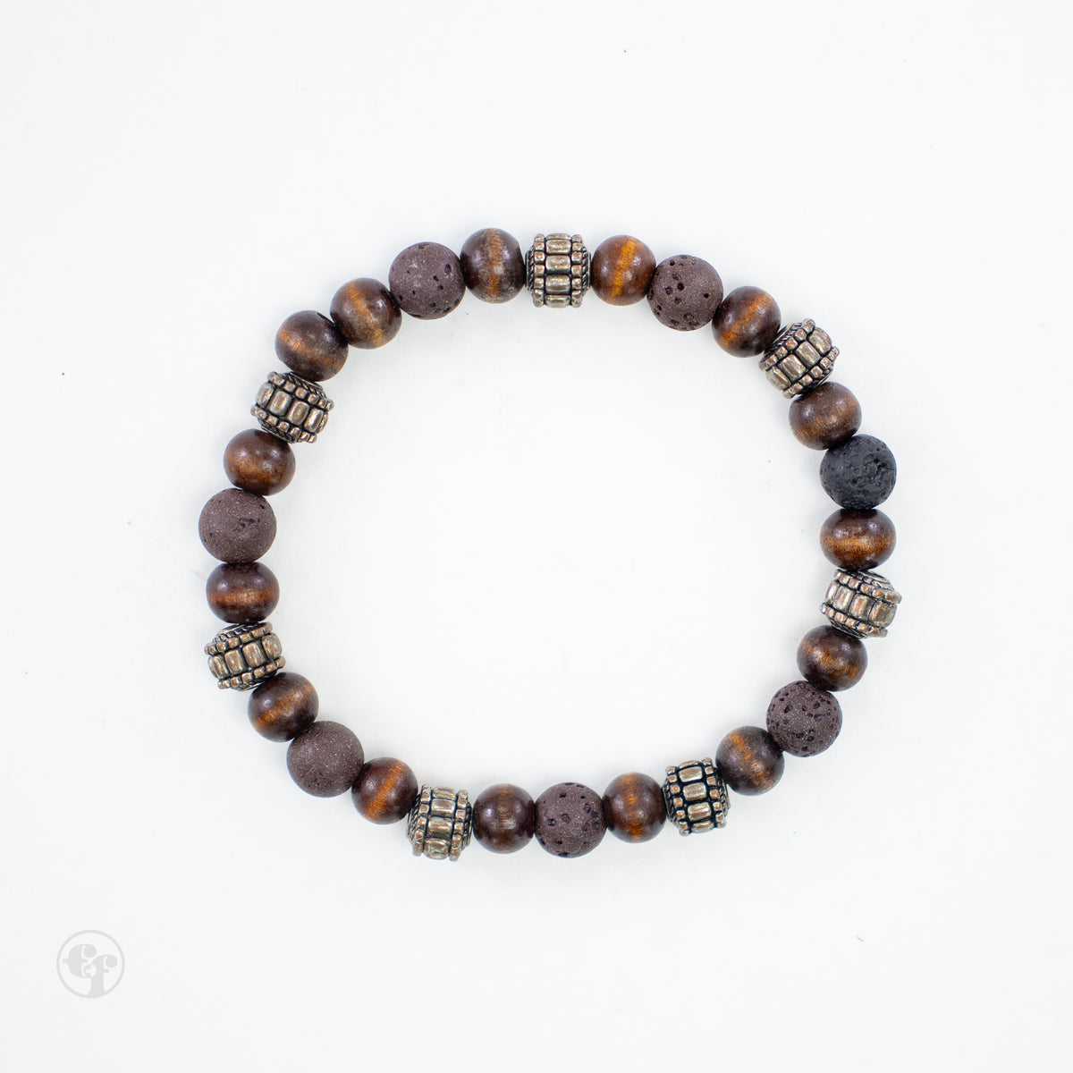 Top-down view of brown lava stone and wood beads with textured metallic barrel accents and a dark porous bead.