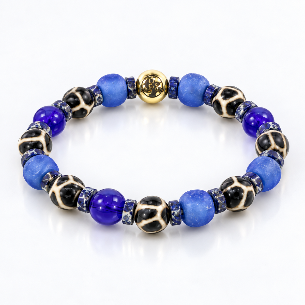 Three-quarter view of a blue bead bracelet with frosted-looking and glossy translucent beads, black-and-cream patterned beads, marbled blue spacers, and a gold-tone emblem.