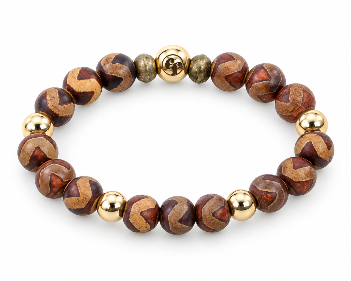 Three-quarter view of brown and rust beads with tan chevron patterns, polished gold-tone accents, and a gold-tone emblem bead.