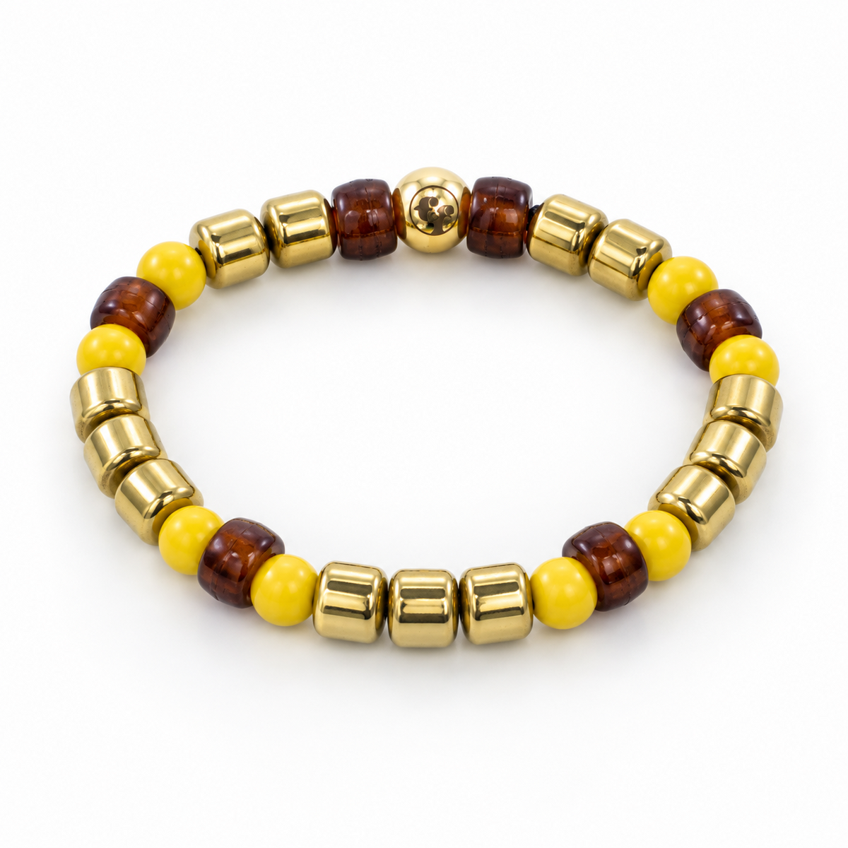 Three-quarter view of a bracelet with yellow round beads, translucent amber-brown barrel beads, polished gold-tone barrel accents, and an emblem bead.