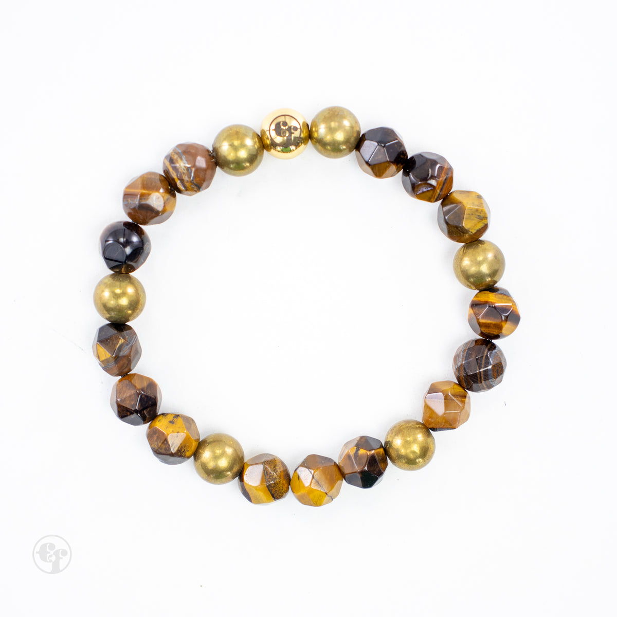 Top-down view of a tiger’s eye bracelet with faceted brown beads, weathered gold-tone accents and an emblem bead.